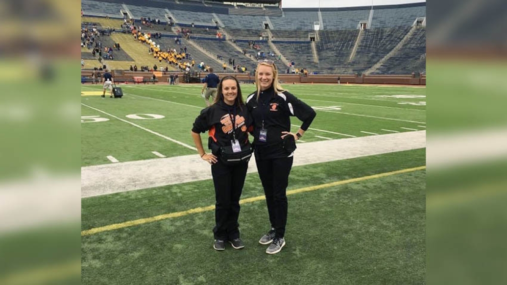 two females on the field at michigan big house