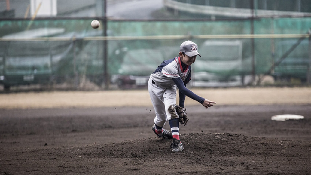 Boy pitching ball 