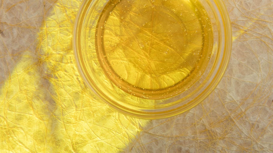 cup of honey on decorative beige surface