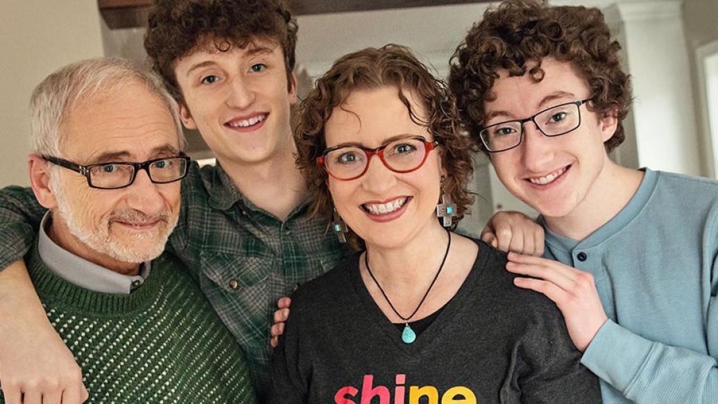 Family smiling and hugging one another