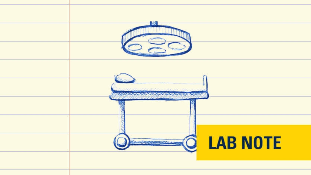 Surgery table under light yellow surgery badge