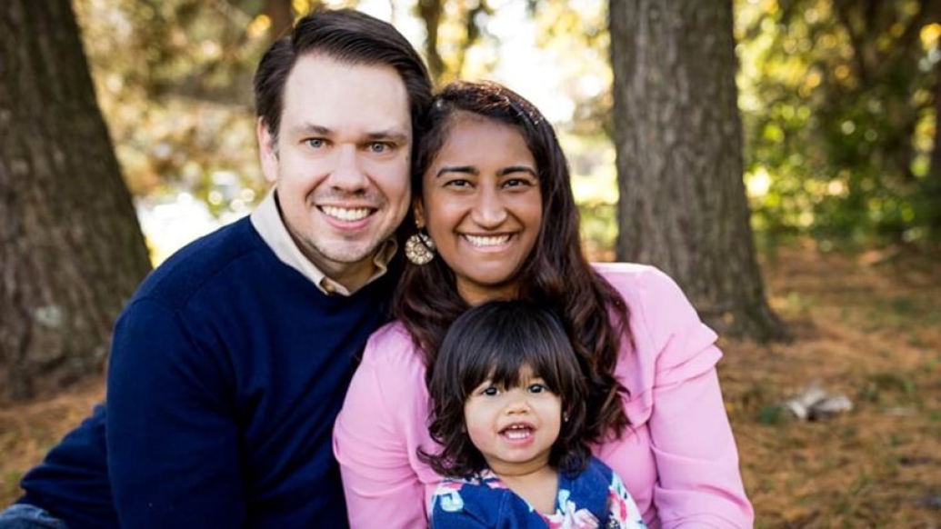 family smiling together at camera