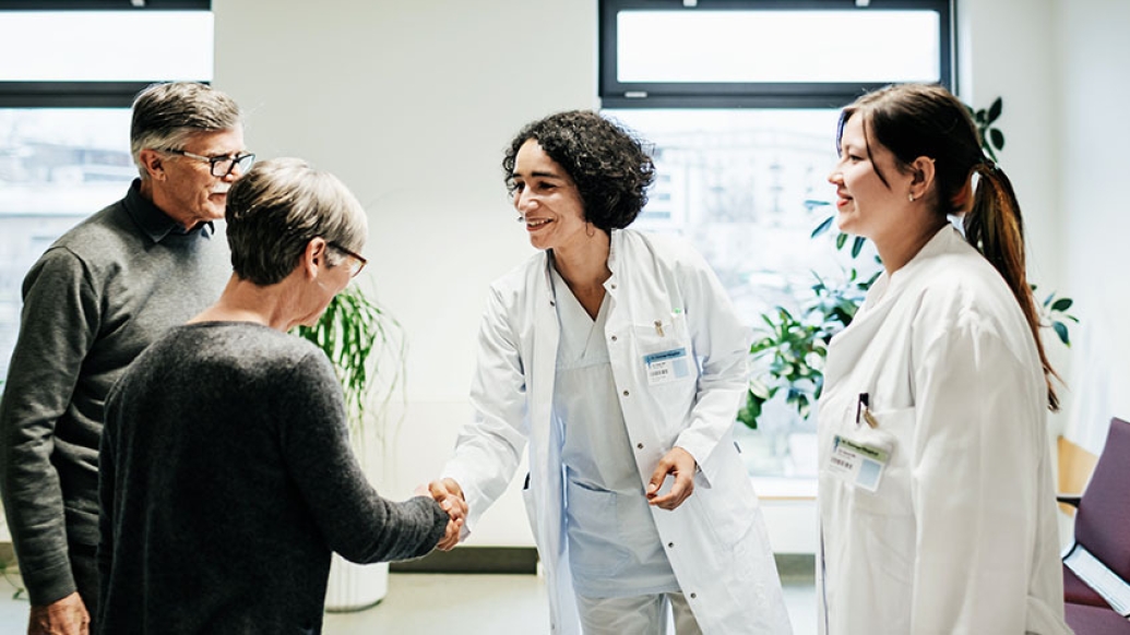 doctors shaking hand of patient in waiting room