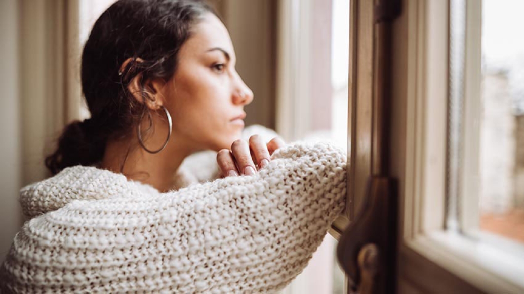 Female looking out window