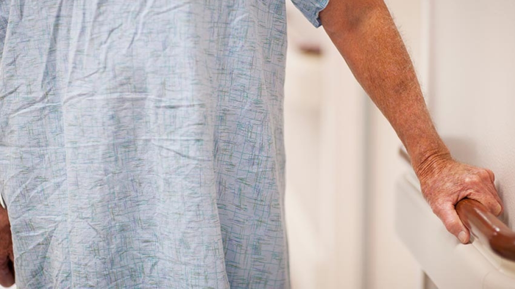 Patient holding onto rail in hospital
