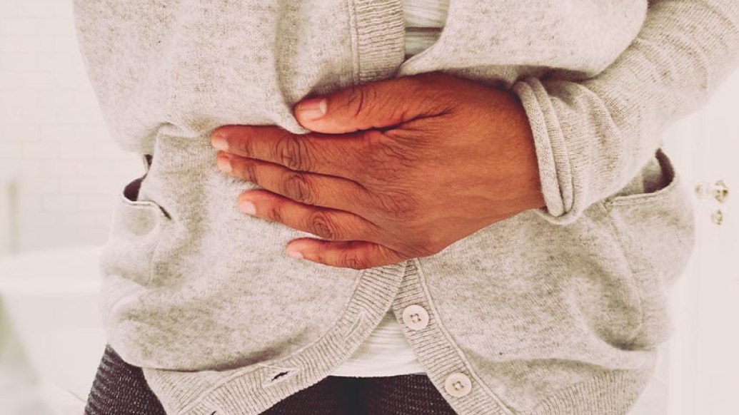 person holding stomach in pain