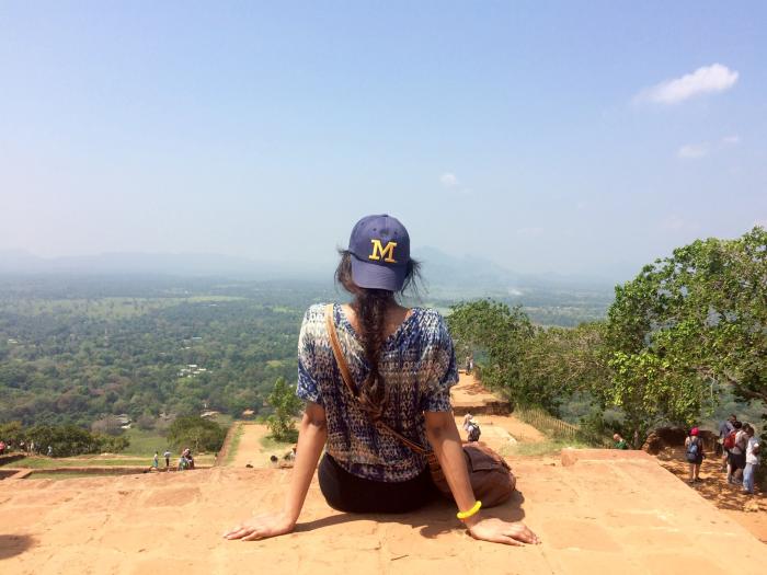 Woman sitting overlooking Sri Lanka landscape
