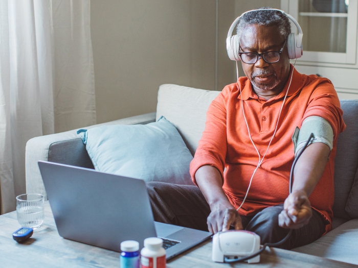 Senior Man Headphones Laptop Cuff