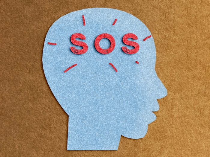 SOS in the brain red words and blue drawing of a side face and brown background