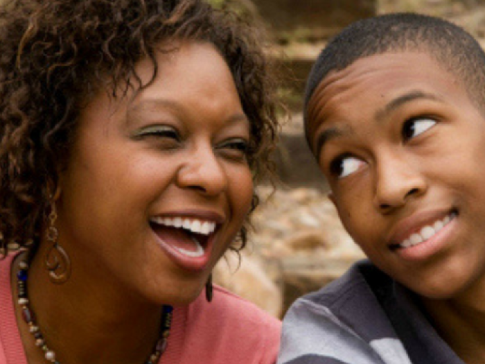 two teens smile next to each other
