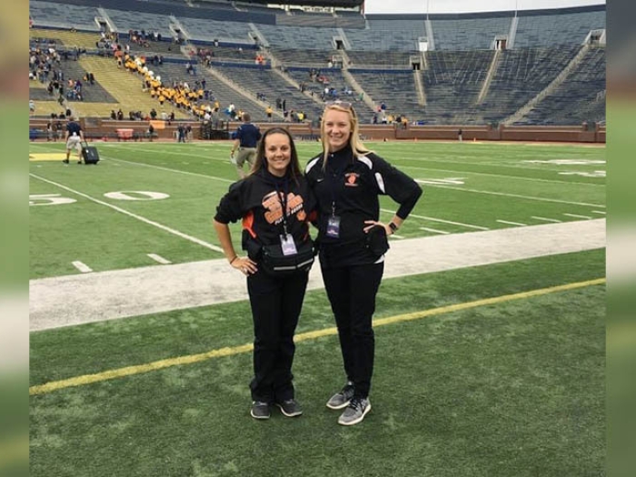 two females on the field at michigan big house
