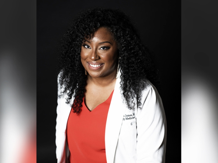 doctors smiling headshot red shirt and white coat