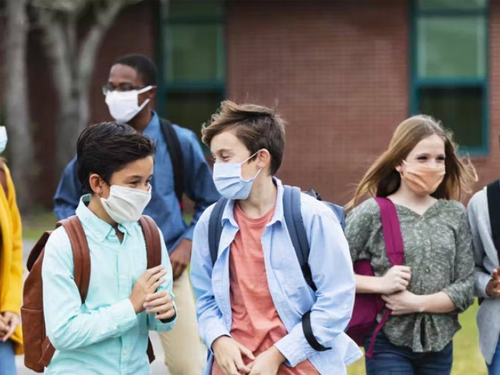 Children at school talking while walking with friends