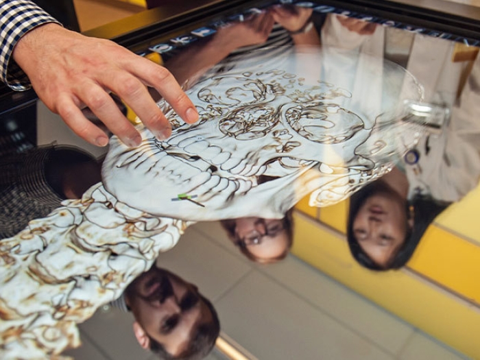 close students standing anatomy table