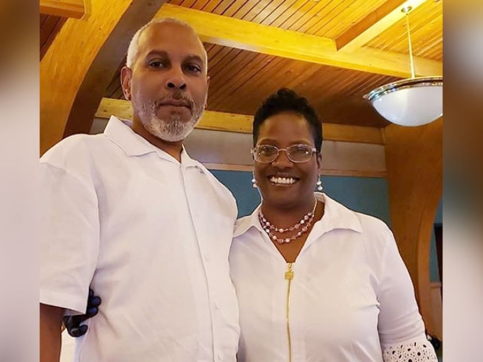 husband and wife smiling wearing white shirts