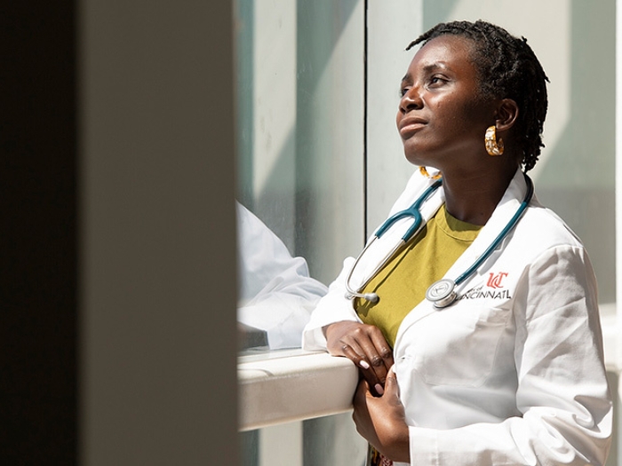 doctor smiling window hallway sunlight