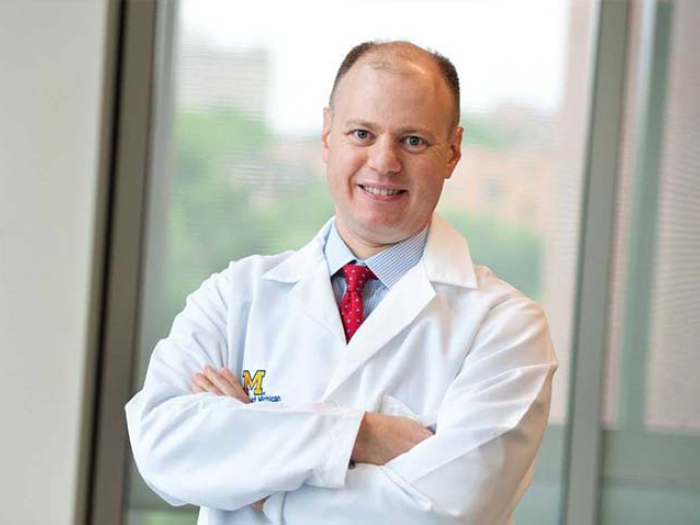 Doctor Stein with arms crossed smiling