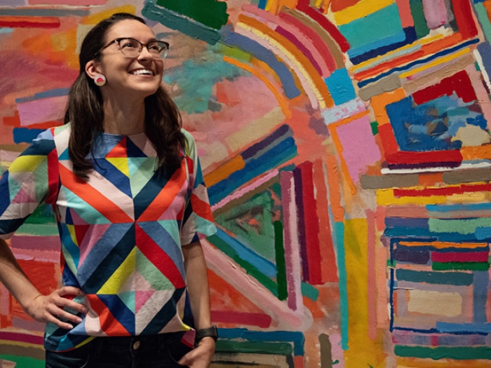 Woman in front of painting 