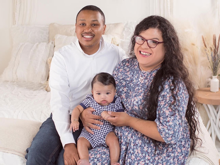 Couple sitting together with baby on lap