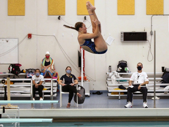 Girl doing a dive into swimming pool