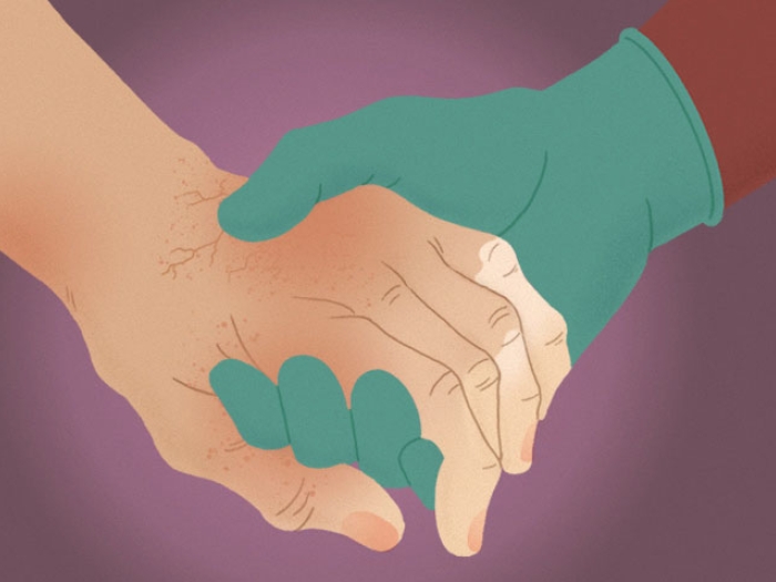 Patient holding hand with doctor wearing medical glove