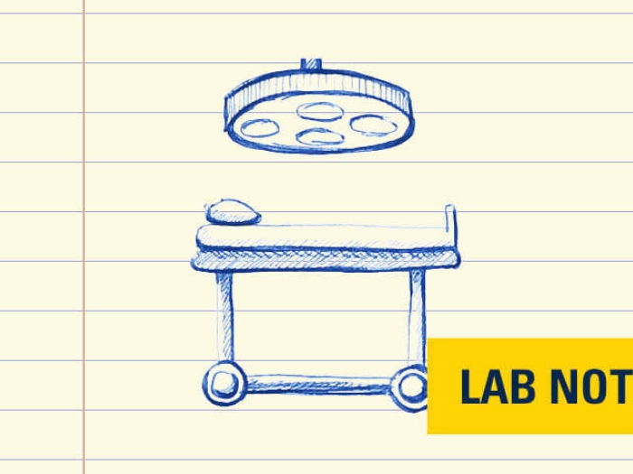 Surgery table under light yellow surgery badge