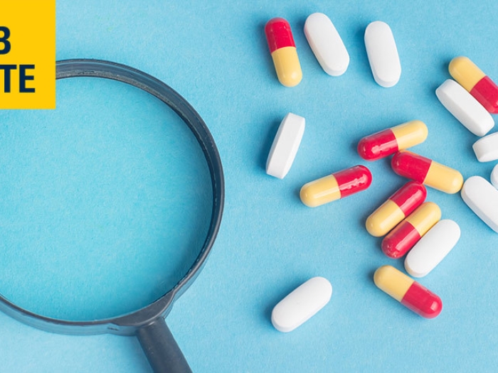 Magnifying-Glass-Pills-Blue-Background