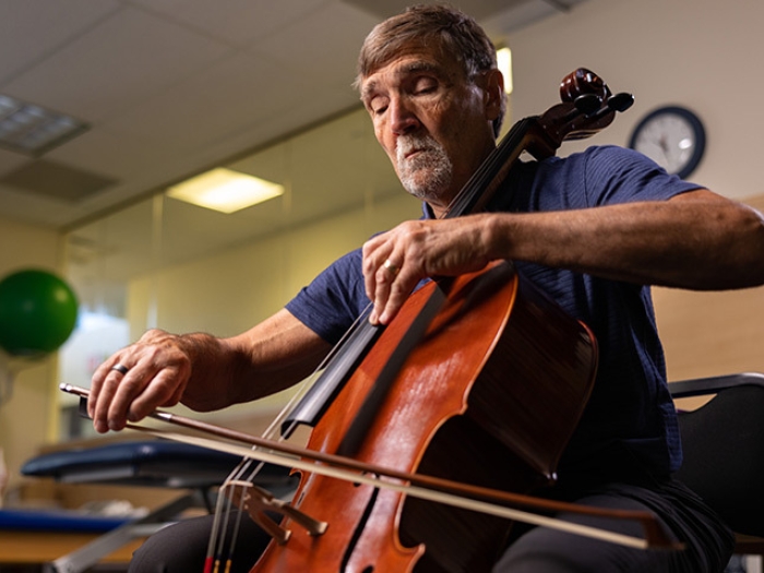 man playing instrument cello bass