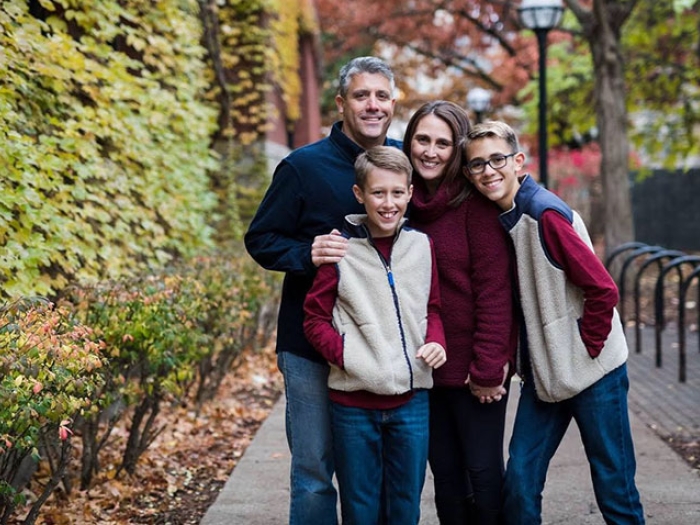 The Bergquist family on a path with autumn trees behind them.