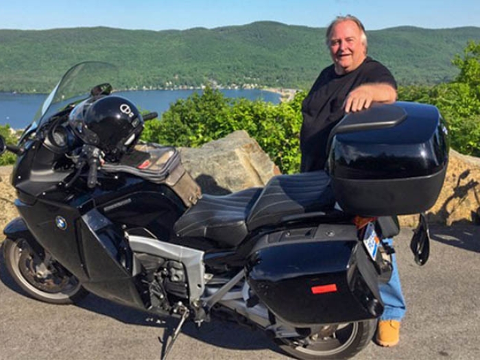 Patient standing next to his motorcyle.