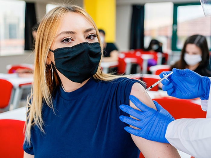 ten girl getting vaccine in arm