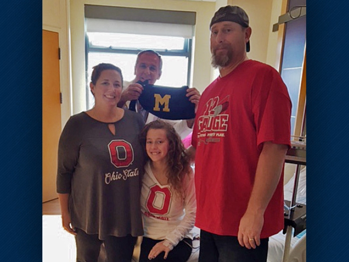 Olivia and her family of Ohio State fans with their U-M doctor