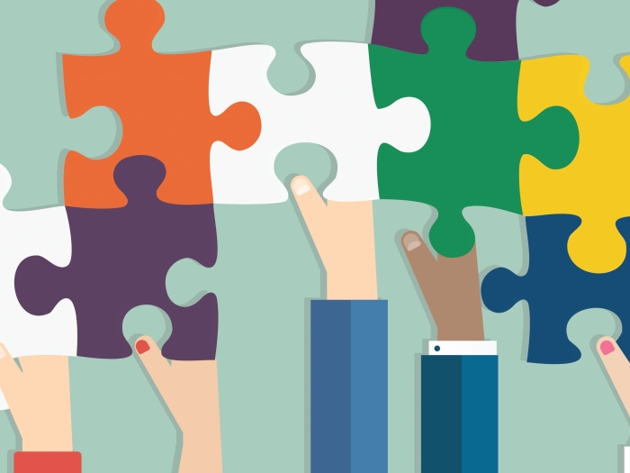 Hands working together to complete a puzzle representing the palliative care process