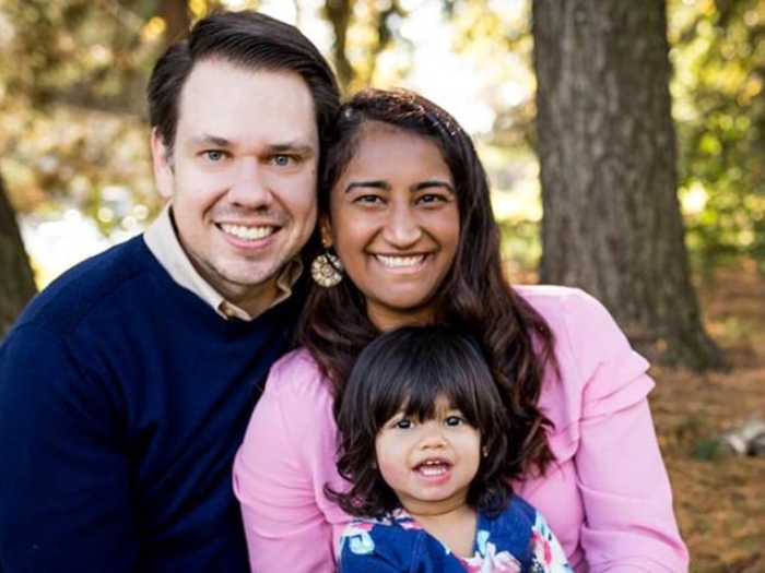 family smiling together at camera