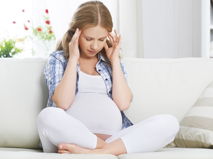 Woman with headache symptoms during pregnancy