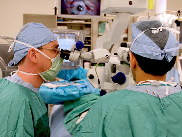 Two ophthalmologists performing retinal detachment surgery