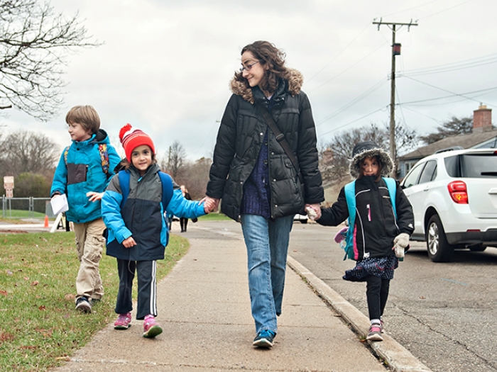 Tori and her three children walking to school