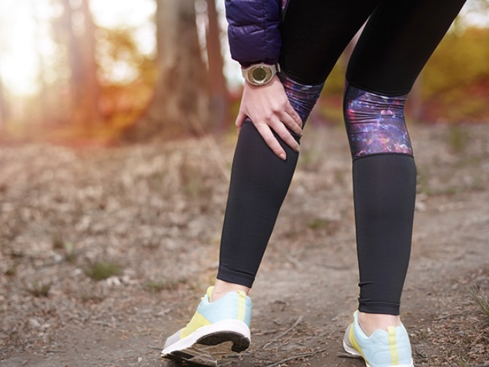 Woman experiencing leg pain from peripheral artery disease