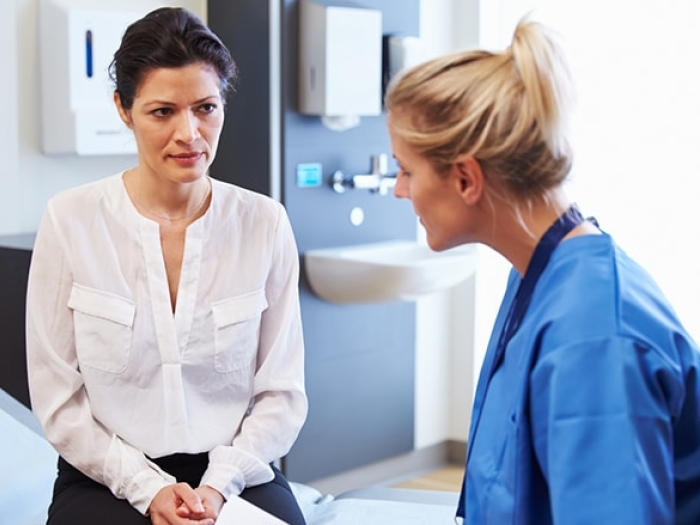Patient talking to her doctor about robotic hysterectomy