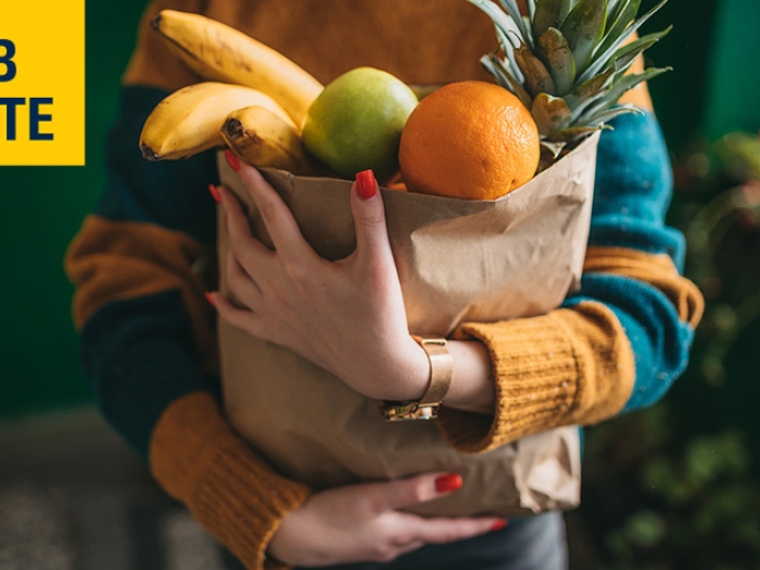 woman holding groceries in bag