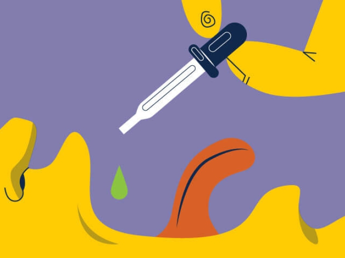 Hand putting cbd drops in mouth for chronic thc pain fibromyalgia