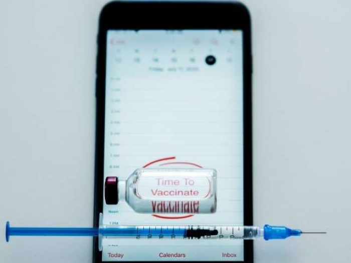 cell phone with vaccine bottle