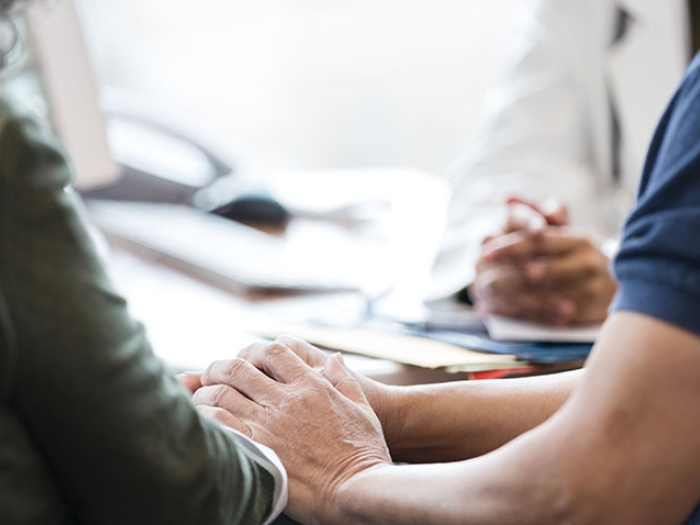 couple holding hands at doctor's office