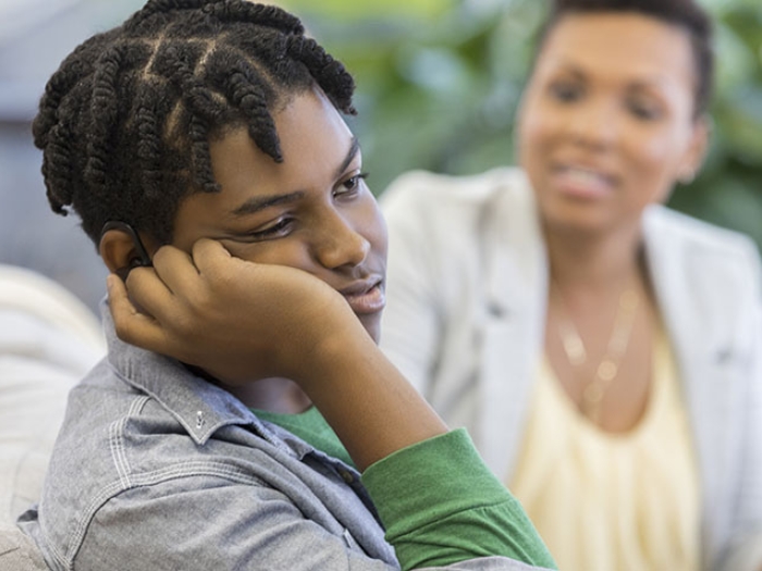 Depressed male teen with mother