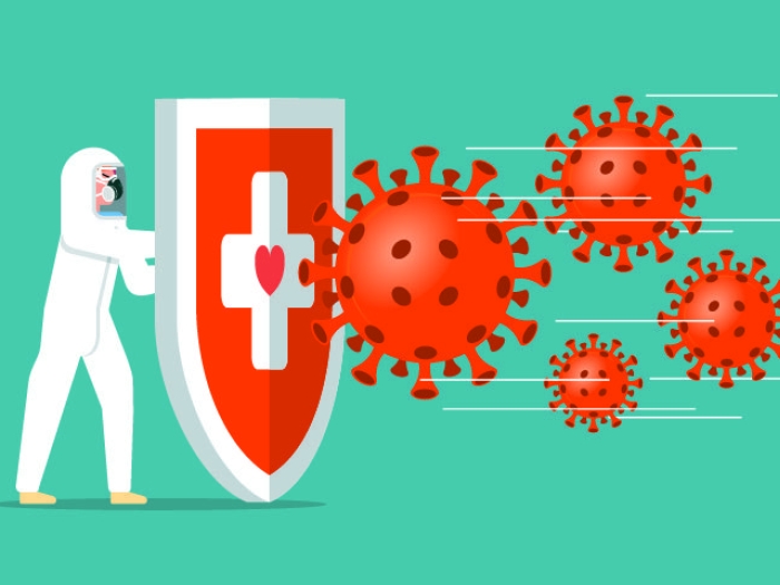 doctor in hazmat suit with shield against covid particles