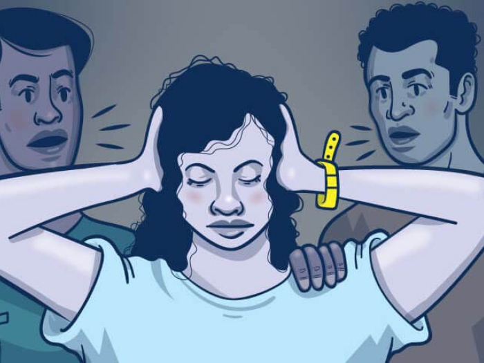 Girl next to her parents covering ears with her hands