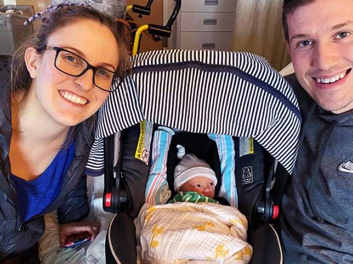 husband and wife with newborn