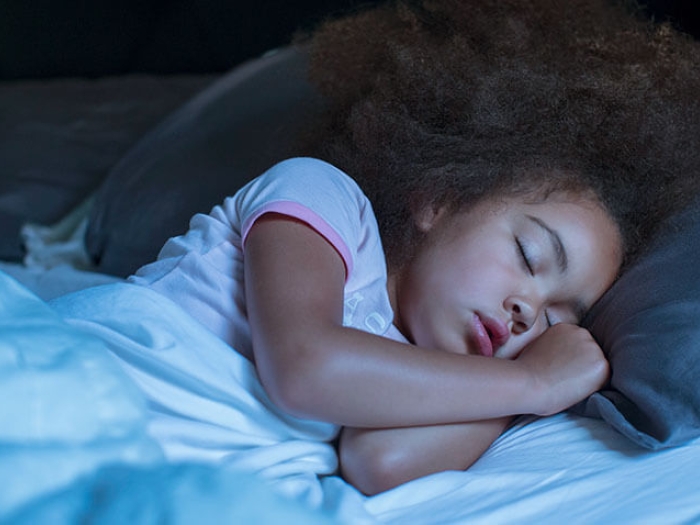 Little girl sleeping in bed