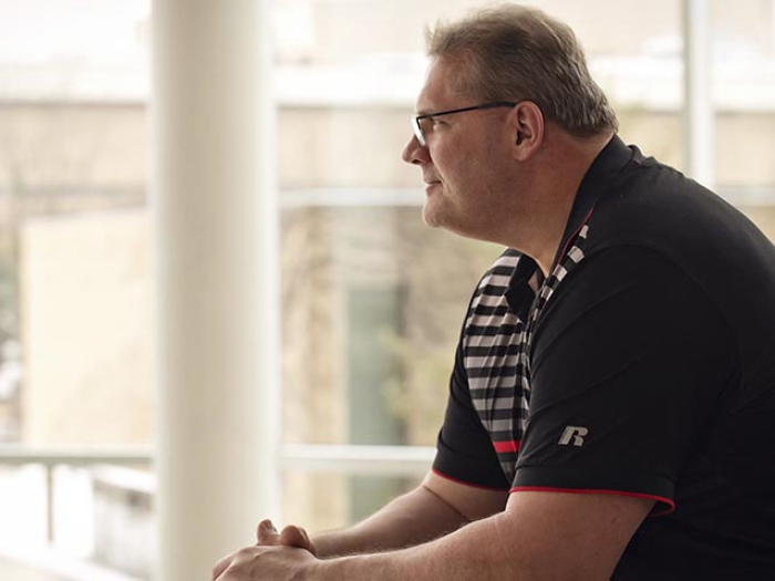 Man looking out window