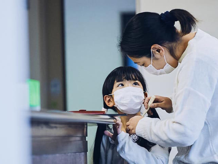 Mother and child with masks at doctors